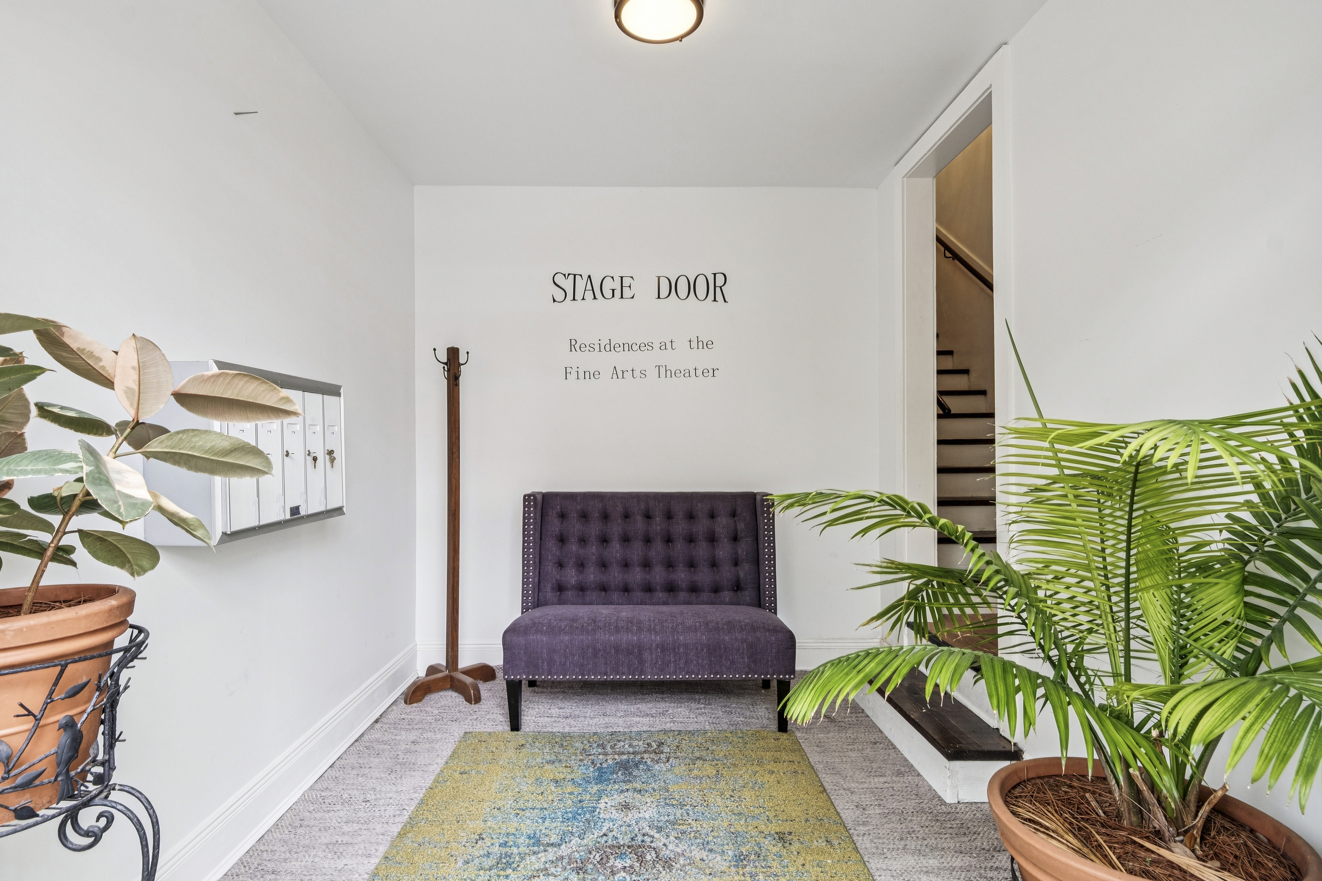 The Stage Door foyer with its hand-lettered sign reading Residences at the Fine Arts Theater