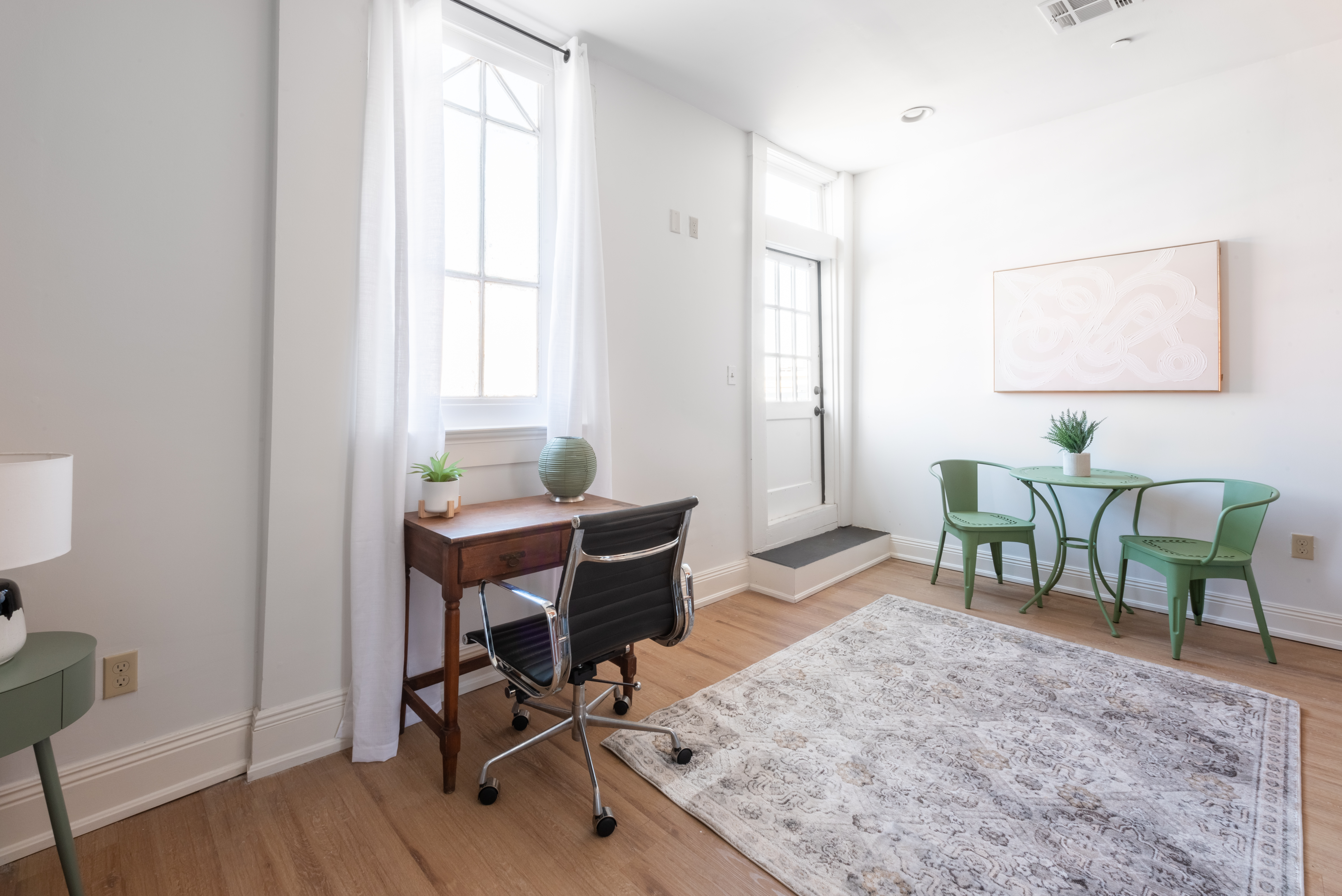 Unit 201 dining nook with green bistro table