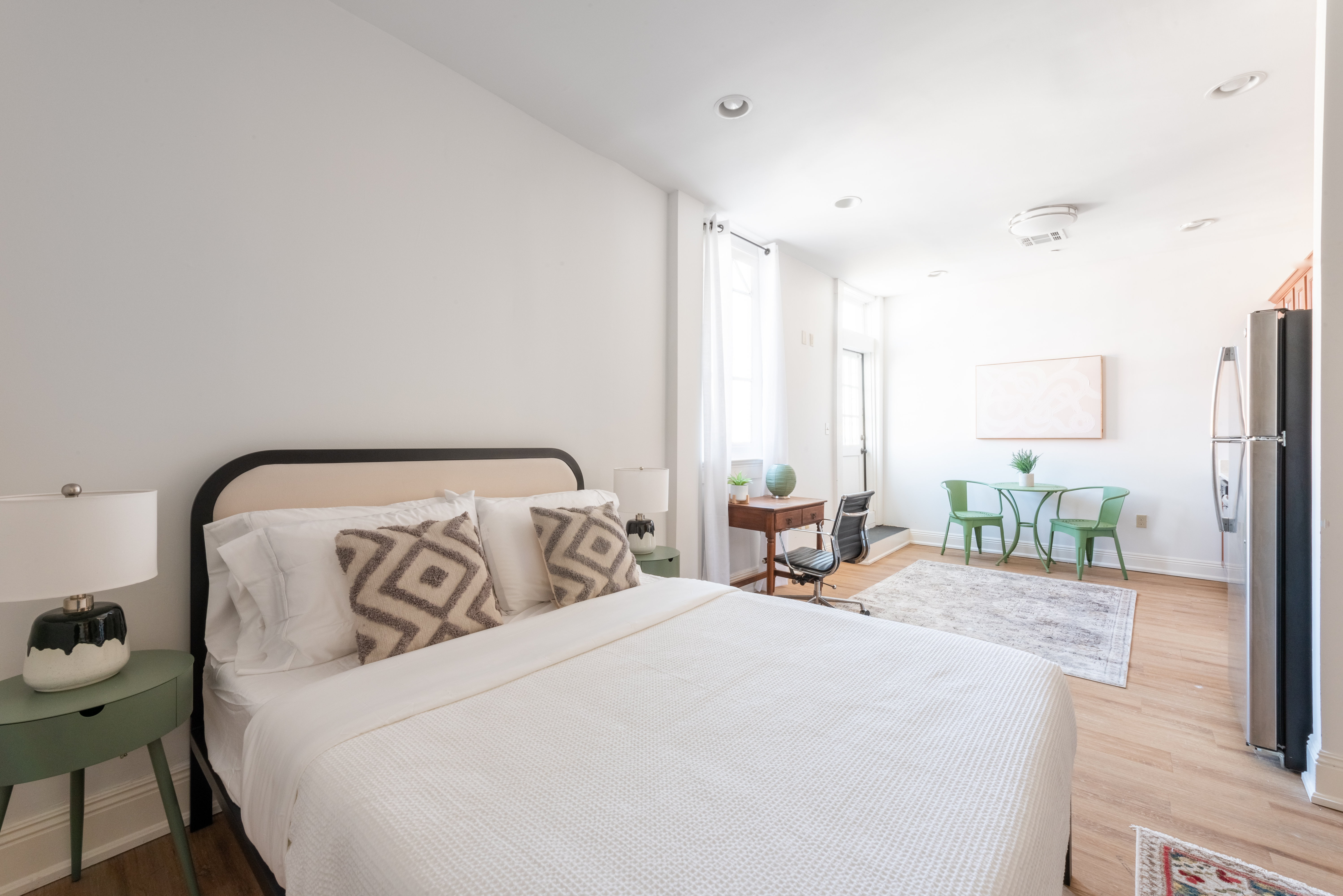 Unit 201 bed and seating with framed art