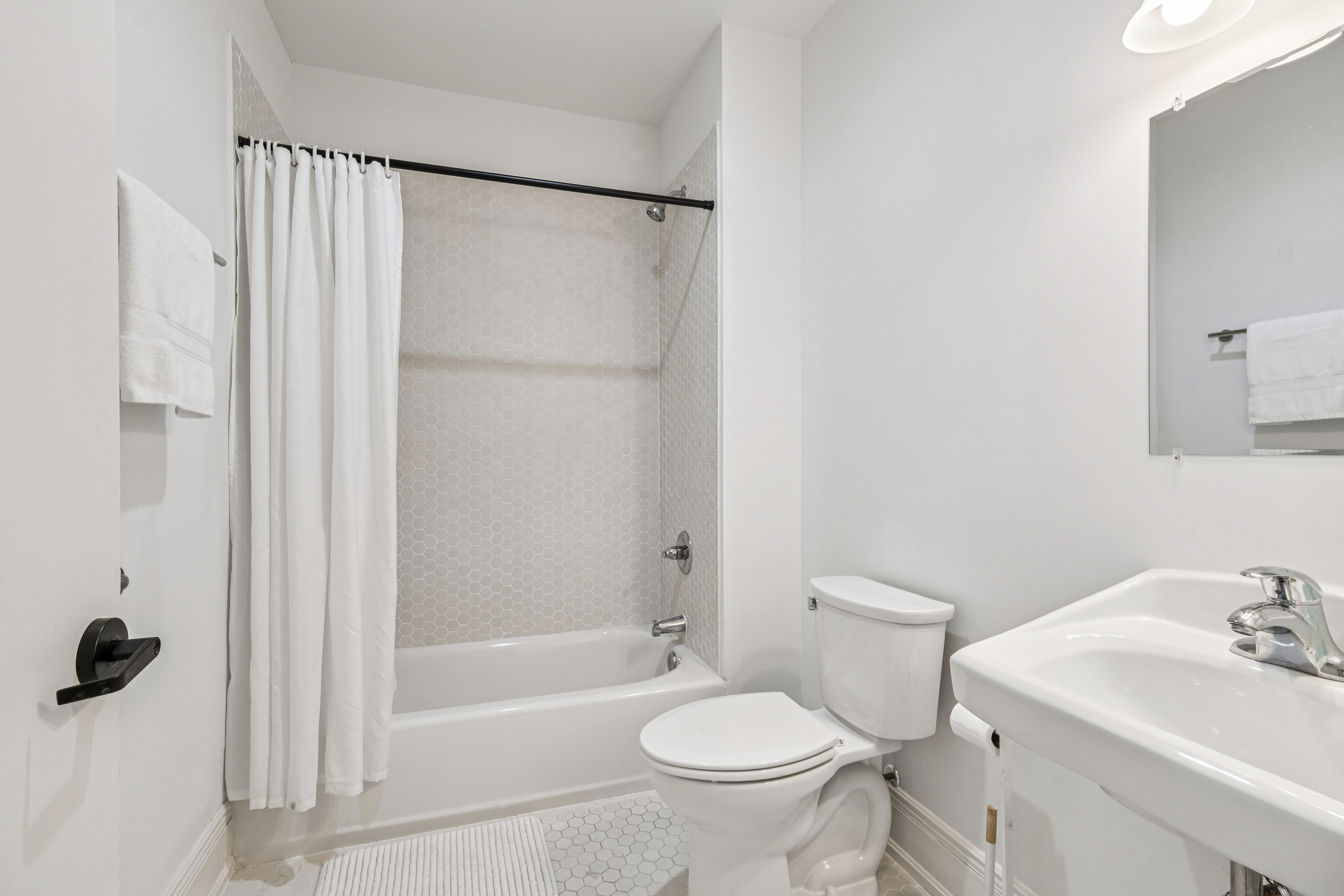 Unit 204 full bathroom with tub and shower