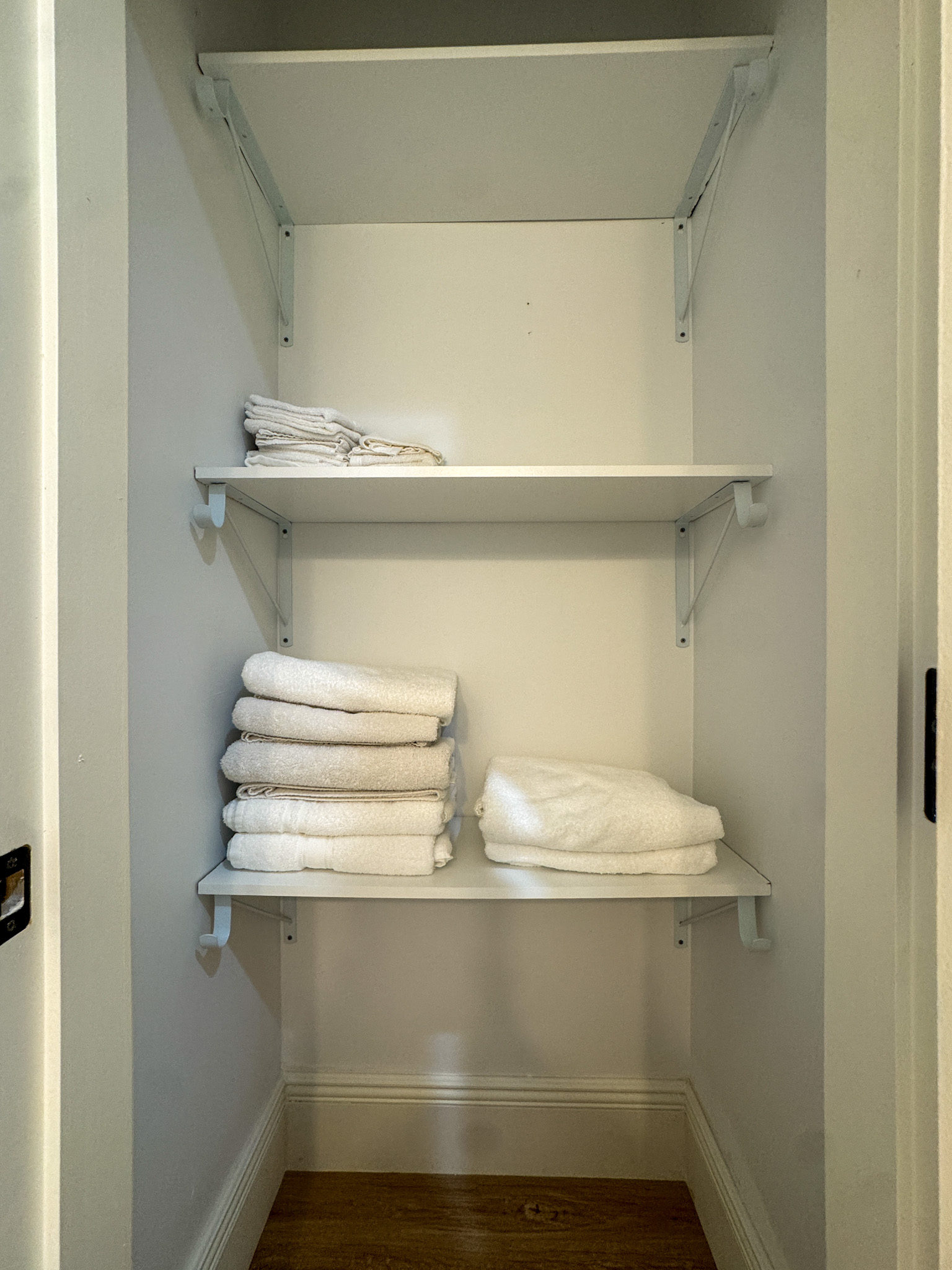 Unit 204 linen closet stocked with fresh towels and bedding